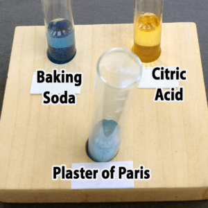 Photo of the results of adding one drop of bromothymol blue to baking soda, citric acid, and plaster of Paris samples