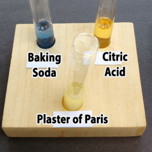 Photo of the results of adding one drop of vinegar to baking soda, citric acid, and plaster of Paris samples